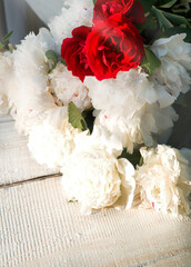 Bouquet of peonies on a table in the garden