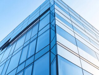 Obraz premium 2408 56.A close-up view of a sleek commercial building with reflective glass windows and aluminum composite panels. The exterior is accentuated by diagonal steel cladding that adds a geometric,