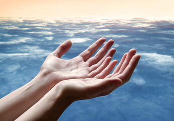 The outstretched hands of a praying man