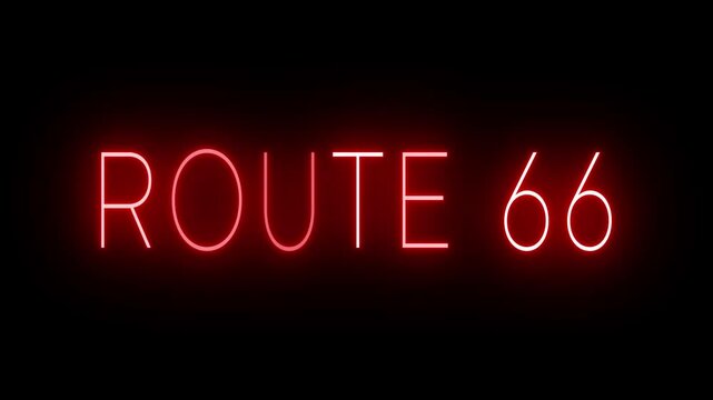 Flickering red retro style neon sign glowing against a black background ROUTE 66
