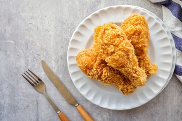Crispy Fried chicken with tomato sauce in white plate on grey background ,top view