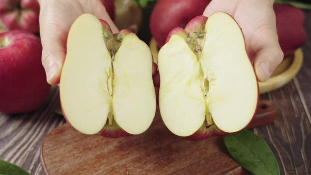Fresh red delicious apple  cut in half on wooden table.