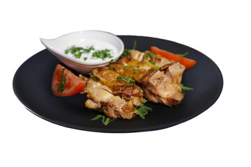 Highlight the succulent, perfectly cooked chicken drumstick and thigh. Ideal for menus, this close-up showcases the crispy, golden skin with tomatoes on a plate.