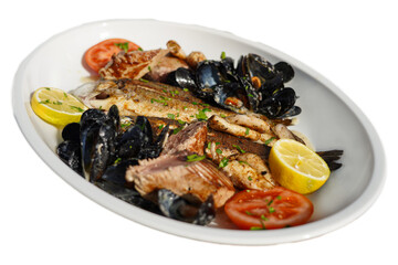 Highlight the mussels with the fish on the plate. Perfect for menus, this close-up shot highlights vivid colors and textures.