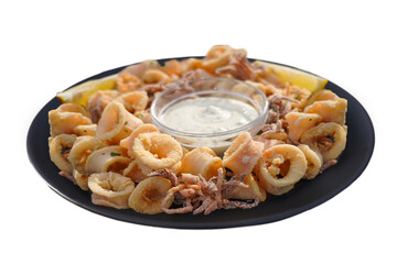 Captured fried calamari with a crispy, golden texture on a plate with a creamy sauce. This image highlights the deliciously crispy exterior, perfect for seafood menus or food blogs.