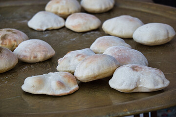 Traditional Egyptian flat bread with wheat bran and flour, regular Aish Baladi or Egypt bread baked in extremely hot ovens, it is the result of a mixture of wheat flour, yeast, salt and water