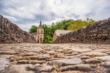 View from the cobblestones of the medieval bridge in the old village of Belcastel, Occitanie, France