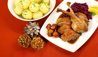 Roasted Christmas Goose on a Plate and red Place mat with Christmas Decoration