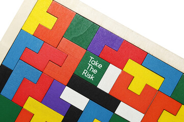 The word TAKE TEH RISK written on colorful wooden blocks