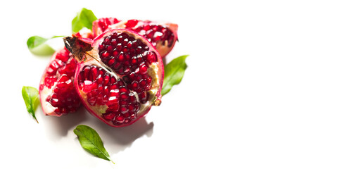 Pomegranate. Fresh juicy Pomegranates with leaves isolated on a White plate Background. Organic Bio...