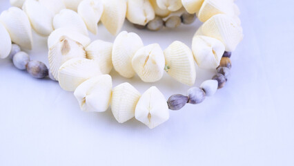Vintage necklace close-up on a white background, handmade, shells, marine theme, women's accessory, beauty, style, retro, naturalness