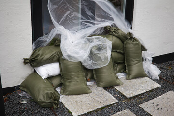 Sandbags outside door of closed restaurant due to flooding