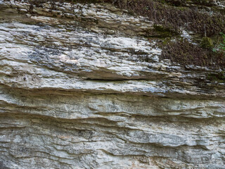 Sheer cliffs frame ancient ruins, reminiscent of past greatness, creating a mystical atmosphere and sense of time