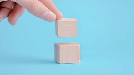 Wooden Block Symbols for Communication, a hand arranging wooden blocks representing telephone, email, and website, illustrating contact options in a marketing context