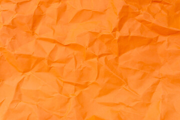 Top view and full frame of wrinkled or crumpled orange paper texture used as crumpled paper...