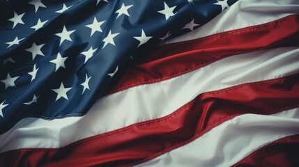 Closeup of the american flag featuring stars and stripes with a cross in the bottom right corner