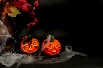 Yask-ol-lanterns with webs,speeders on a black background,decoration Halloween, selective focus