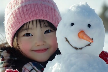 happy child in knitted hat playing with snowman in winter weather snow lifestyle outdoor