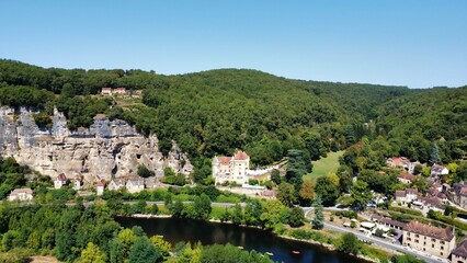 

Photo of a castle and village built into the rock, seen from a drone