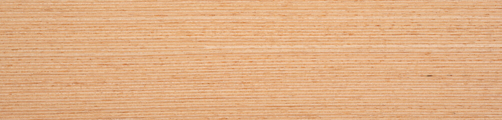 Warm peach and soft cream hues cascade across the smooth grain of this beechwood veneer surface