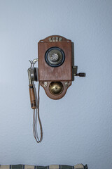 Old wooden telephone on a wall