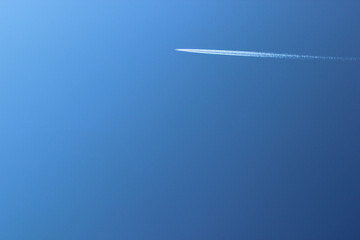 Airplane in the blue sky. Far away