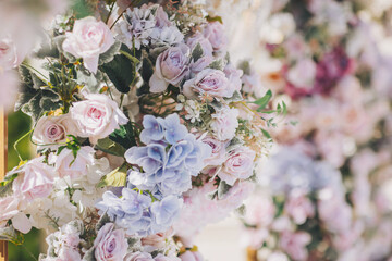 wedding flower backdrop background, fresh rose, bunch of flower. Floral arrangement with roses for garden party. Beautiful wedding ceremony set-up outdoors.