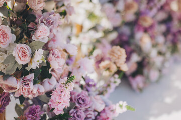 wedding flower backdrop background, fresh rose, bunch of flower. Floral arrangement with roses for garden party. Beautiful wedding ceremony set-up outdoors.