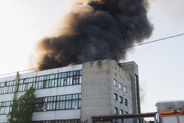 Massive large blaze fire in the city, blazing warehouse factory, storage building is burning,...