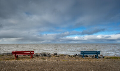 Wooden benches on the shore of the Arctic Ocean at Tuktoyaktuk, Northwest Territories, Canada