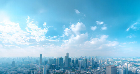 Naklejka premium Aerial View of City Skyline and Skyscrapers Under Blue Sky and White Clouds