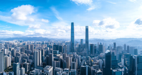 Fototapeta premium Aerial View of City Skyline and Skyscrapers Under Blue Sky and White Clouds