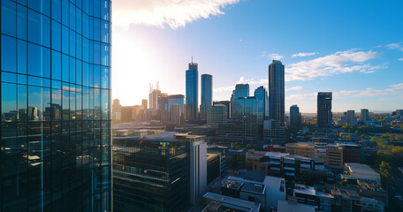 Obraz premium Aerial View of City Skyline and Skyscrapers Under Blue Sky and White Clouds