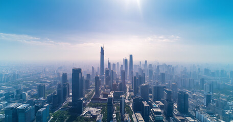 Fototapeta premium Aerial View of City Skyline and Skyscrapers Under Blue Sky and White Clouds