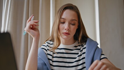 Businesswoman analyzing financial documents in office environment closeup.