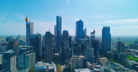 Obraz premium City Skyline and Skyscrapers Under Blue Sky and White Clouds Aerial View