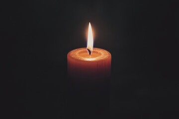 Single Candle Flame in Darkness
