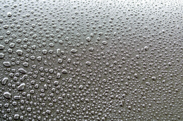 Straight view of rain droplets on dark cover background. Rain droplets and wallpaper design concept