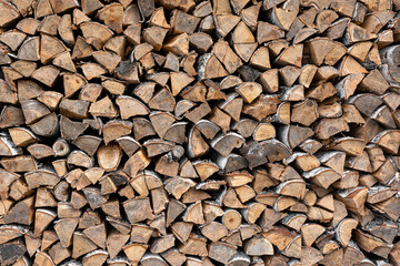 A large stack of birch wood for a fire. A rural lifestyle.