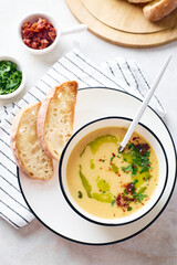 Bowl of potato soup with parsley and bacon with toasted bread croutons in white bowl. Comfort meal