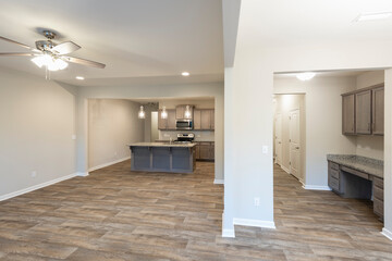 Empty modern townhouse floor showcasing a kitchen, a workspace, living, and dinning room ready to be moved in. Investment, renting, or house ownership concept.
