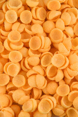 corn snack cheese flavor top view in shell shape isolated background portion close-up