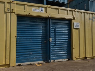 Secure code lock on a storage container with roller shutters.