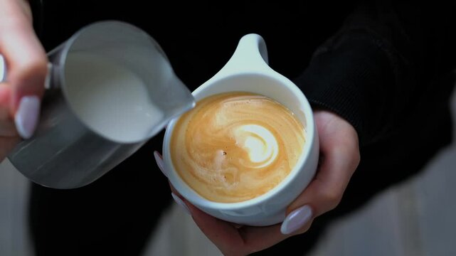 person making a latte art coffee
