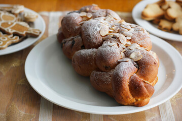 Traditional Czech and Slovak Christmas sweet plaited bread called vanocka (in Slovak vianocka). Handmade Christmas pastry on a festively set table.