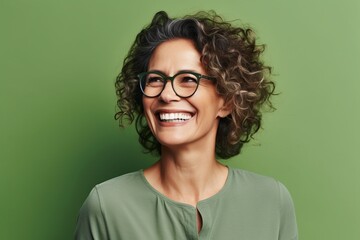 Portrait of young happy woman with curly hair and eyeglasses
