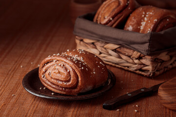 Korvapuusti, traditional finnish cinnamon and cardamom rolls, fresh baked buns on the plate, sweet dessert Sweden and Finland
