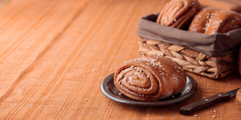 Korvapuusti, traditional finnish cinnamon and cardamom rolls, fresh baked buns on the plate, sweet dessert Sweden and Finland