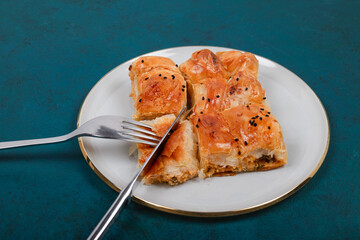 Freshly Baked Traditional Borek Being Cut on Plate – Crispy Pastry with Cheese Filling, Perfect for Turkish Cuisine and Mediterranean Food Concepts