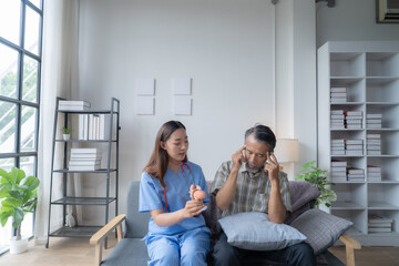 Nurse explains brain anatomy to a senior man at home, using a model to discuss memory loss and cognitive health. This visit offers crucial support for his well-being